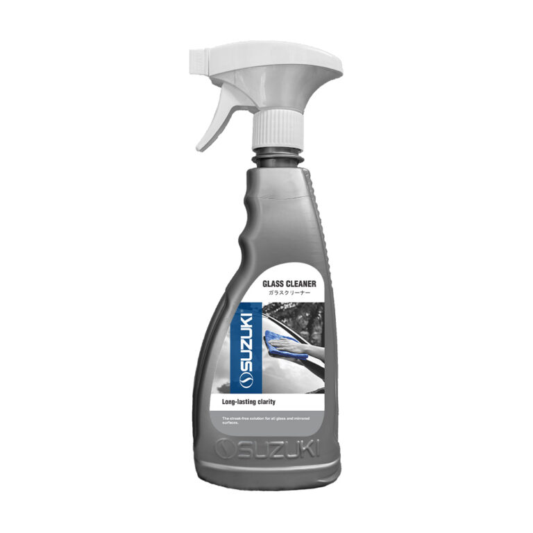 Grey spray bottle of Suzuki Glass Cleaner featuring a label with a car window cleaning demonstration.