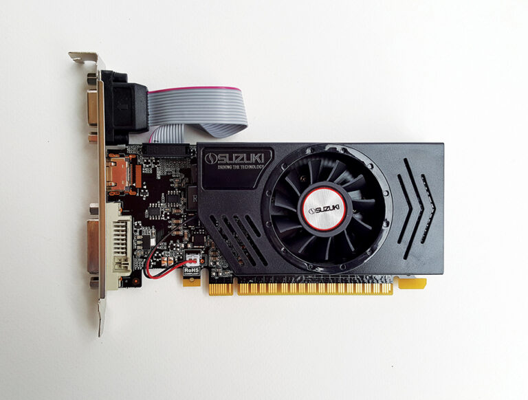 Black Suzuki graphics card with a cooling fan, ribbon cable, and gold PCIe connector on a white background.