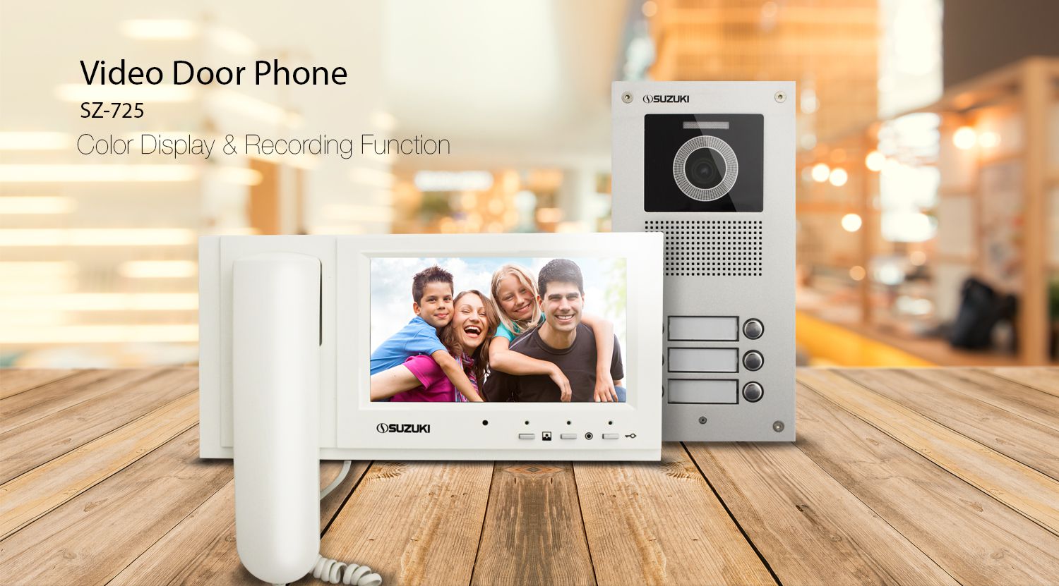 Suzuki SZ-725 video door phone featuring a white indoor monitor with a family on the screen and a silver outdoor camera unit.