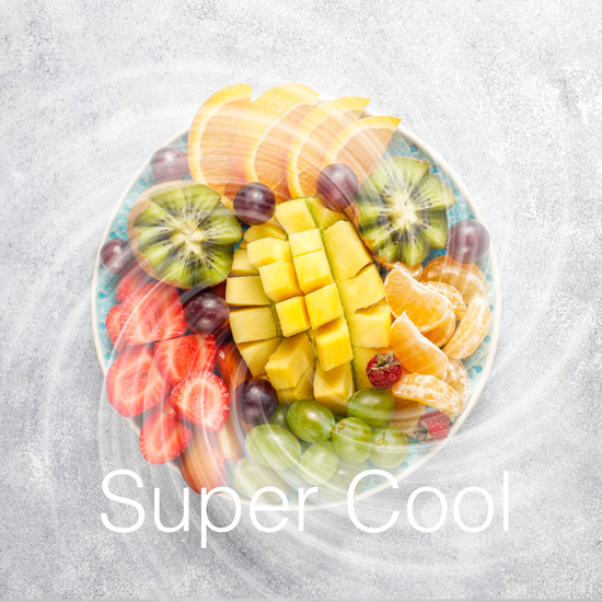 Top down view of a colorful fruit platter with mango, kiwi, and strawberries featuring a frosty swirl effect and the text Sup