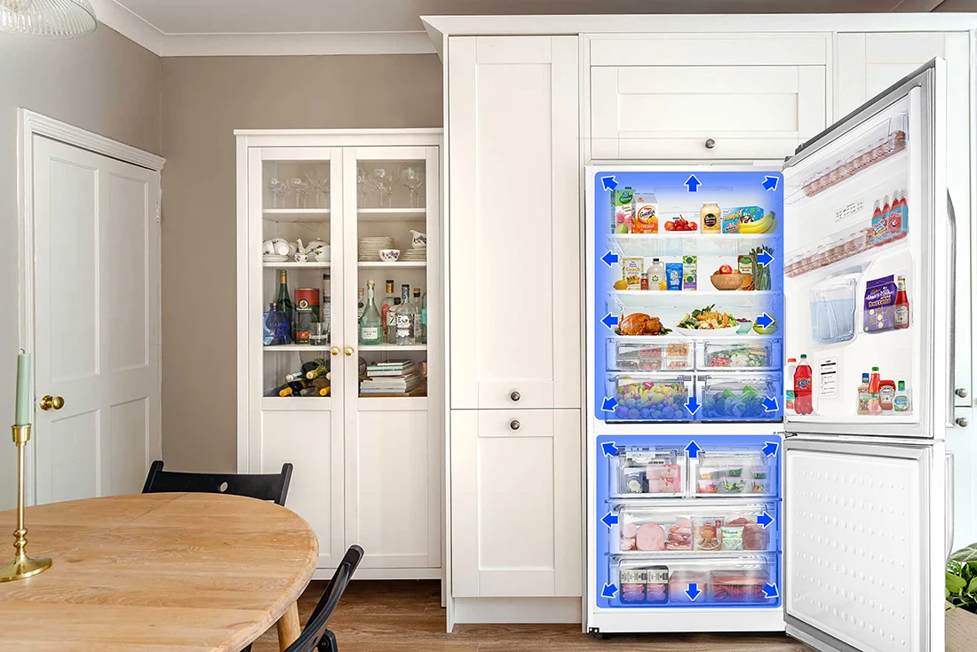 Open white refrigerator with blue arrows showing internal airflow circulation among stored food items.
