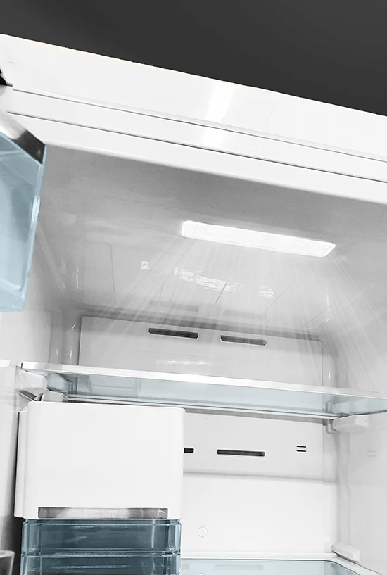 Interior view of a clean white refrigerator featuring glass shelving, a bright LED light, and stylized cooling airflow.